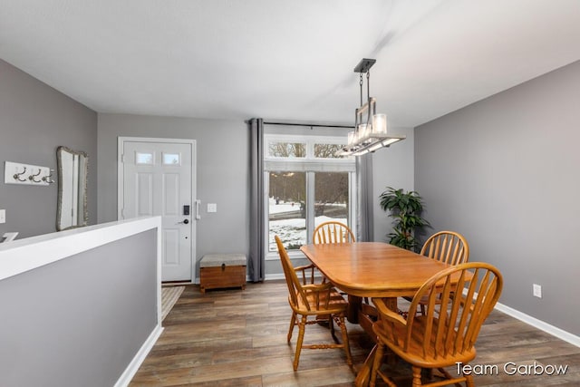 dining area featuring dark hardwood / wood-style flooring and a notable chandelier