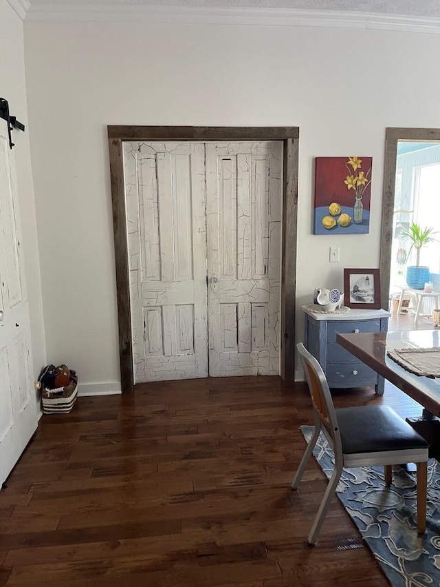 office area featuring crown molding, a barn door, and dark hardwood / wood-style floors