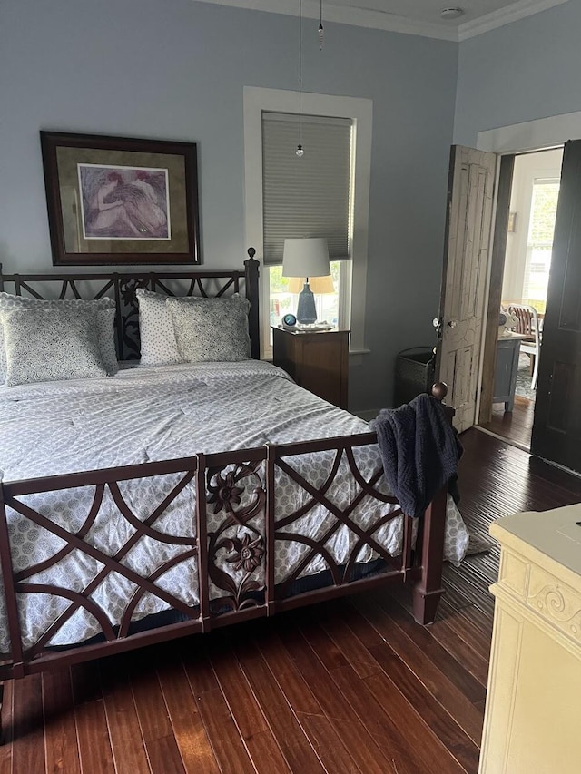 bedroom with ornamental molding and hardwood / wood-style floors