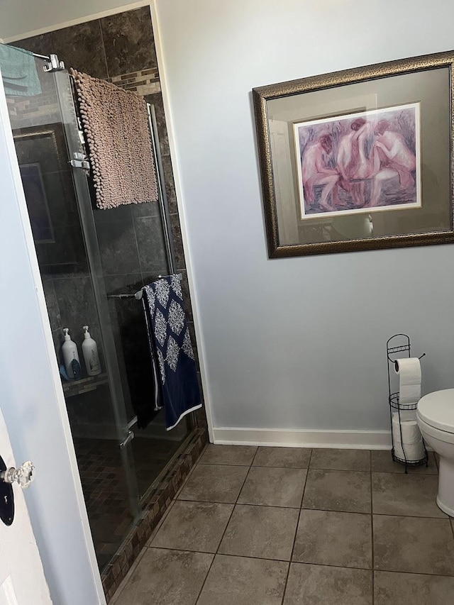 bathroom with toilet and tile patterned flooring