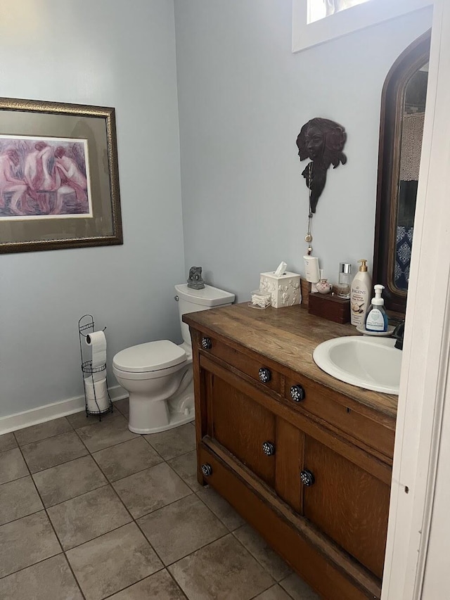 bathroom featuring vanity, toilet, and tile patterned flooring