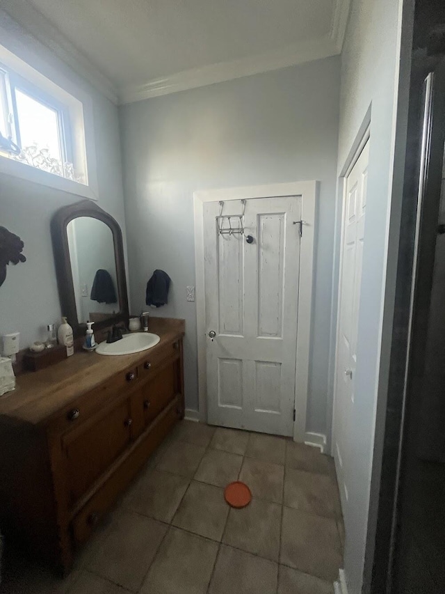 bathroom with tile patterned flooring, vanity, and ornamental molding