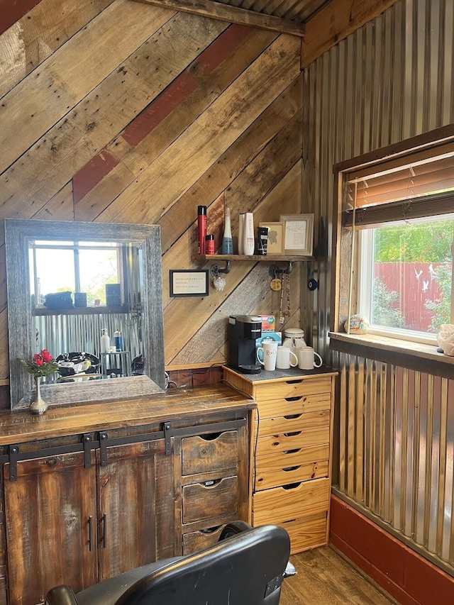 bar with hardwood / wood-style flooring, lofted ceiling, and wood walls