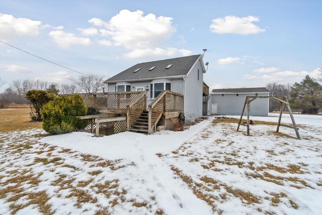 snow covered house featuring a deck