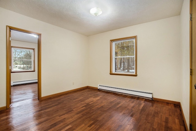 empty room with baseboard heating, plenty of natural light, and dark hardwood / wood-style floors