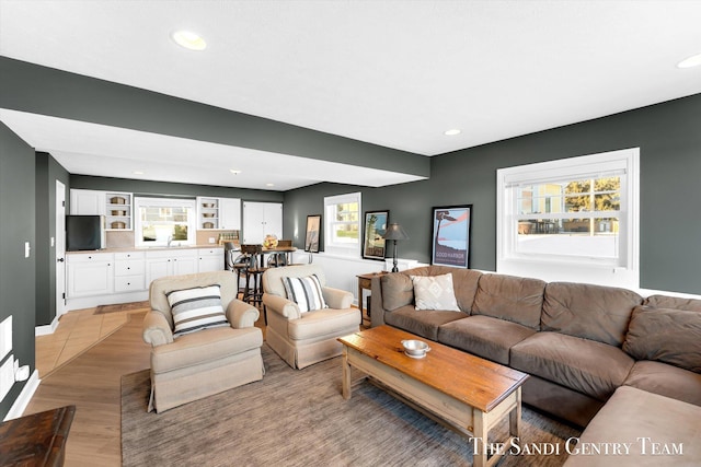 living room with recessed lighting and light wood-style flooring