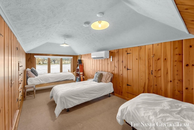 bedroom featuring lofted ceiling, a wall mounted air conditioner, carpet flooring, and wooden walls