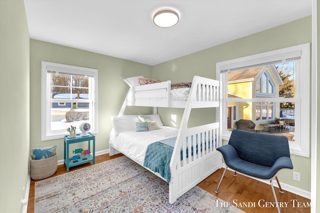 bedroom featuring baseboards and wood finished floors