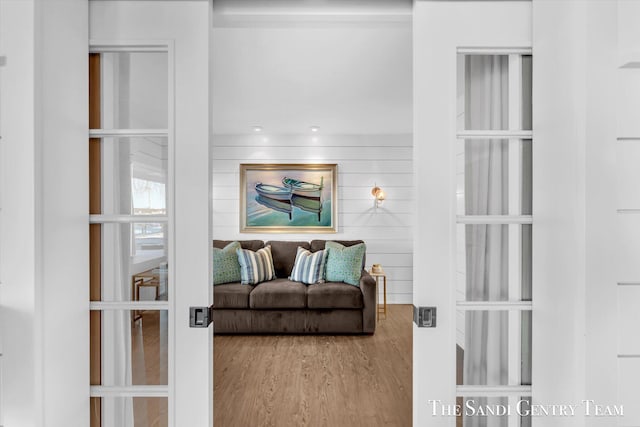 living room with wood walls and wood finished floors