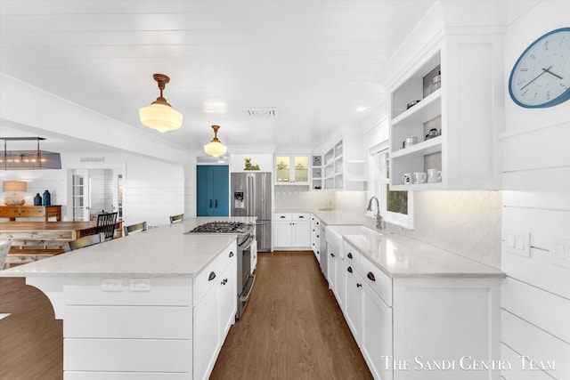 kitchen with visible vents, white cabinets, appliances with stainless steel finishes, light stone counters, and open shelves