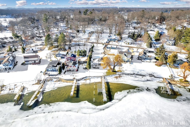 snowy aerial view with a residential view