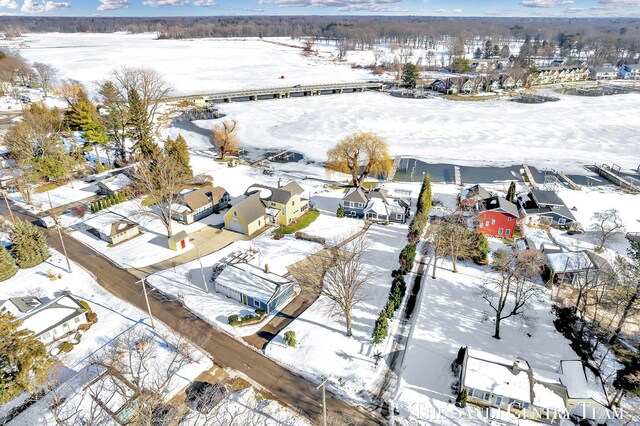 snowy aerial view with a residential view