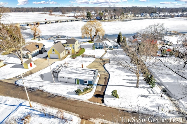 snowy aerial view with a residential view