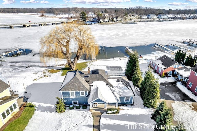 snowy aerial view with a residential view