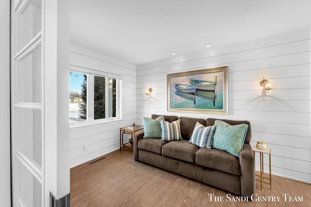 living room with visible vents and wood finished floors