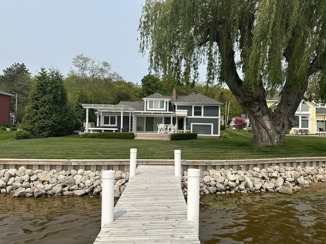 dock area featuring a water view, a lawn, and a pergola