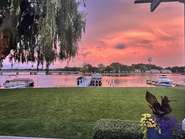 exterior space featuring a yard, a water view, and boat lift