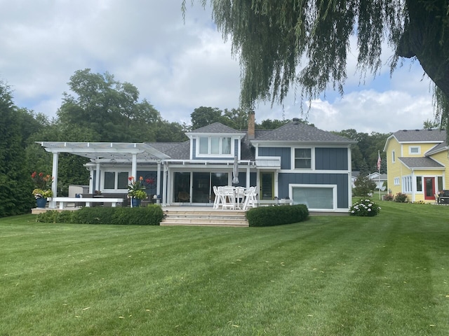 back of property featuring a garage, a lawn, a pergola, and board and batten siding