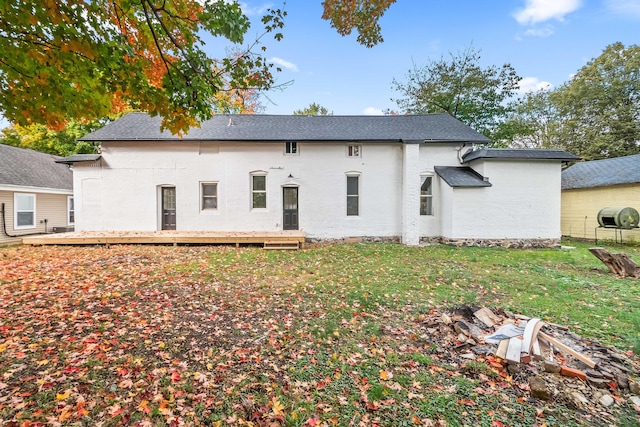 back of house with a lawn