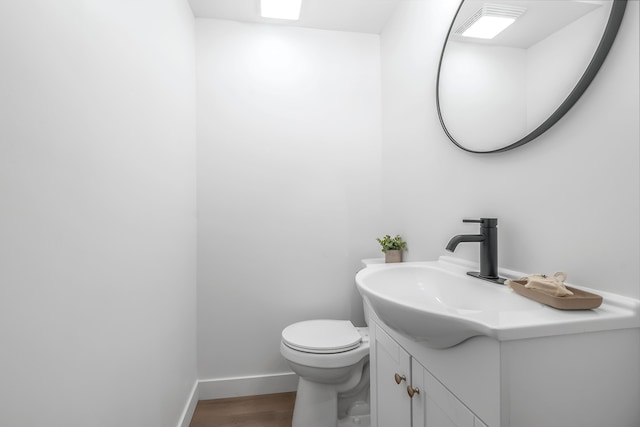 bathroom featuring vanity, toilet, and wood-type flooring