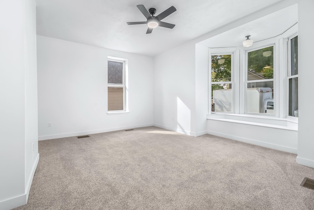 spare room with carpet floors and ceiling fan