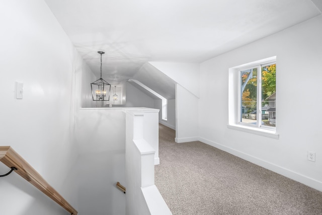 bonus room with a notable chandelier, carpet, and lofted ceiling