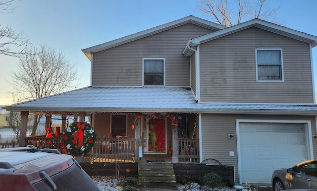 view of front of home featuring a porch and a garage