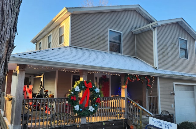 view of front of house with a porch and a garage