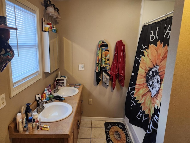 bathroom featuring tile patterned flooring, vanity, and a wealth of natural light