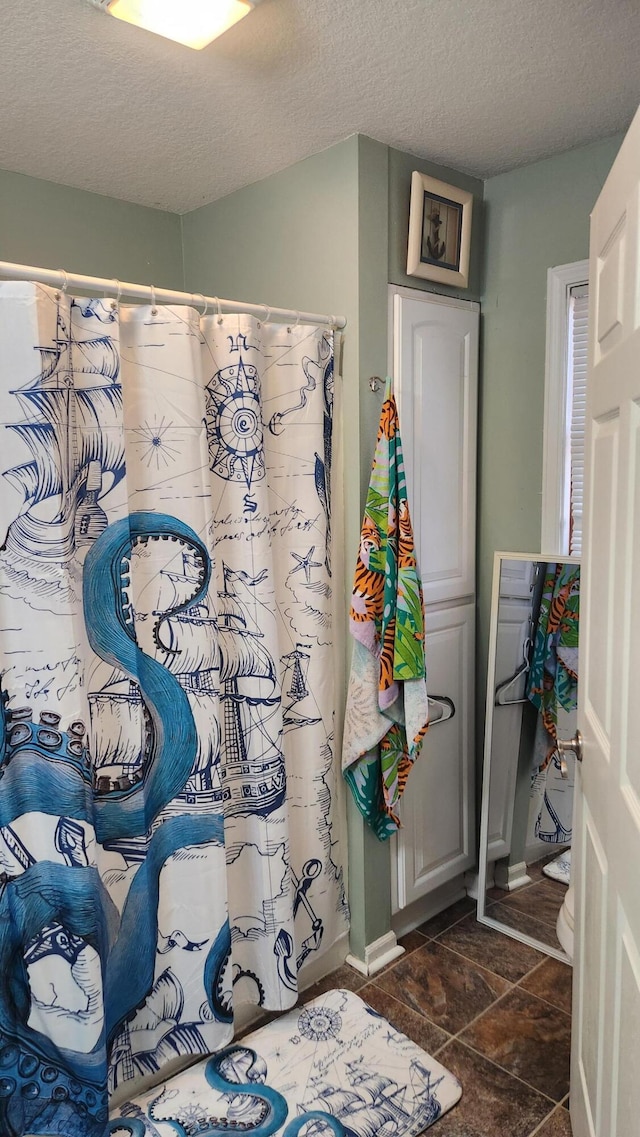 bathroom featuring walk in shower and a textured ceiling