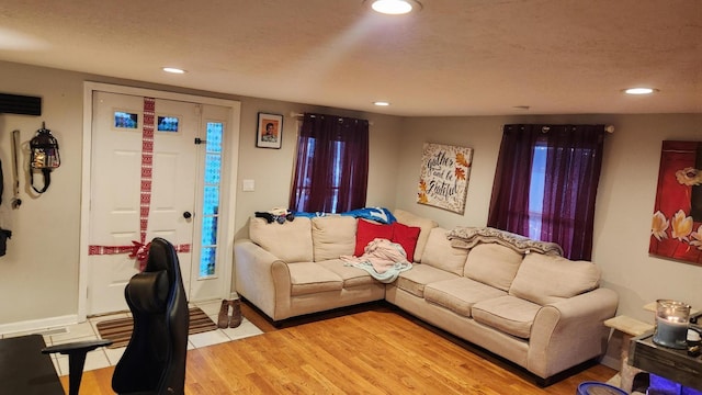 living room featuring wood-type flooring and a textured ceiling