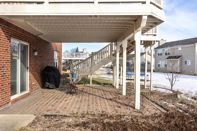 view of patio with area for grilling and a trampoline