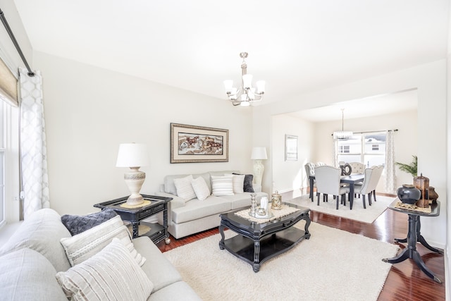 living room featuring an inviting chandelier and hardwood / wood-style flooring