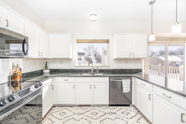 kitchen featuring stainless steel appliances, sink, and white cabinets