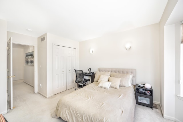 bedroom with a closet and light carpet