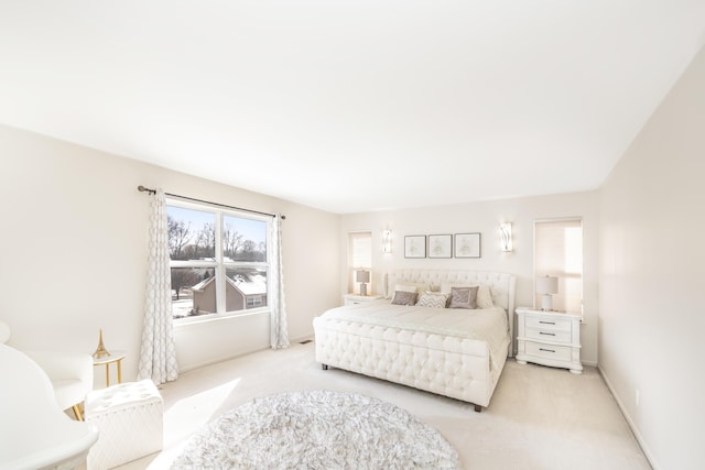 bedroom featuring light carpet