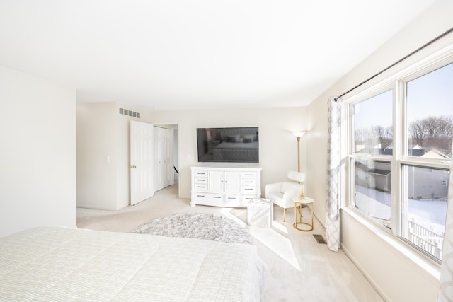 bedroom with light colored carpet