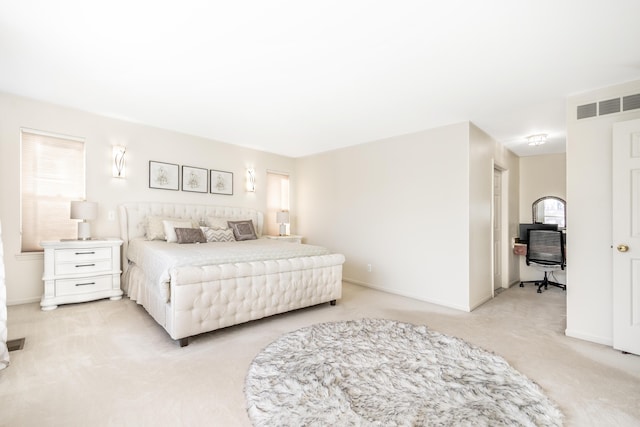 bedroom with light colored carpet