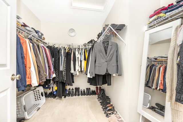 walk in closet featuring carpet flooring