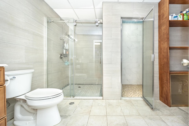 bathroom with vanity, tile patterned floors, a shower with door, and toilet