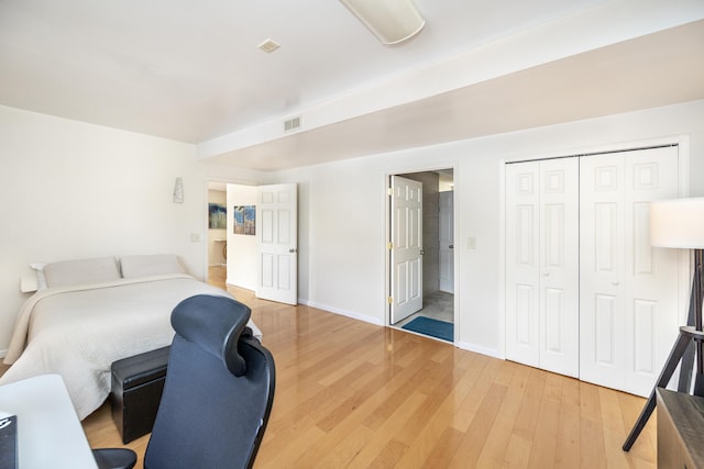 bedroom featuring wood-type flooring and a closet