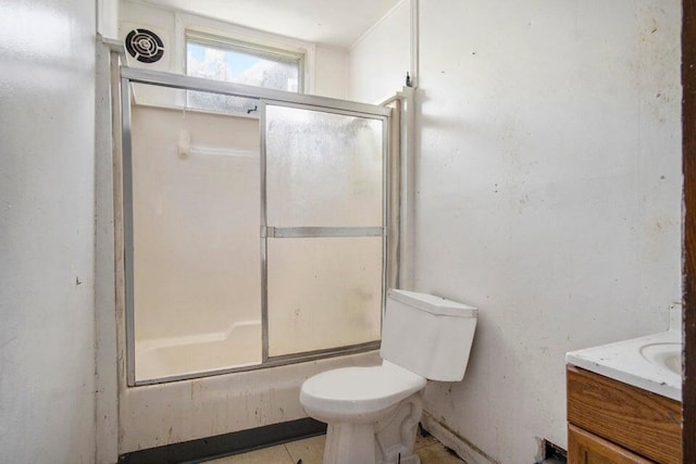 full bathroom featuring vanity, bath / shower combo with glass door, and toilet