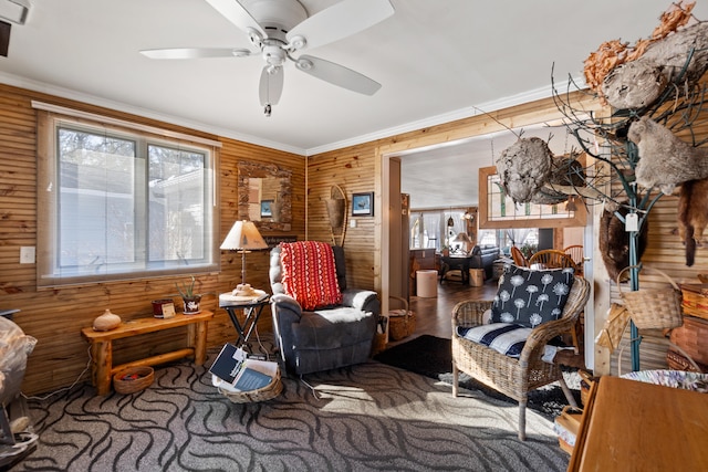 3509 N Shore Dr, Sears, MI 49679 - sitting room featuring crown molding, ceiling fan, and wood walls