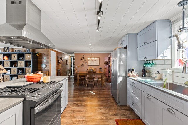 3509 N Shore Dr, Sears, MI 49679 - kitchen with plenty of natural light, wood finished floors, wooden walls, and stainless steel appliances