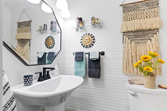 3509 N Shore Dr, Sears, MI 49679 - bathroom with a sink, wooden walls, and toilet