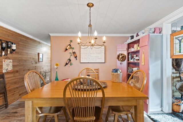 3509 N Shore Dr, Sears, MI 49679 - dining room with wooden walls, a notable chandelier, ornamental molding, and wood finished floors