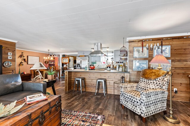 3509 N Shore Dr, Sears, MI 49679 - living room with crown molding, dark wood-style flooring, wood walls, and a chandelier