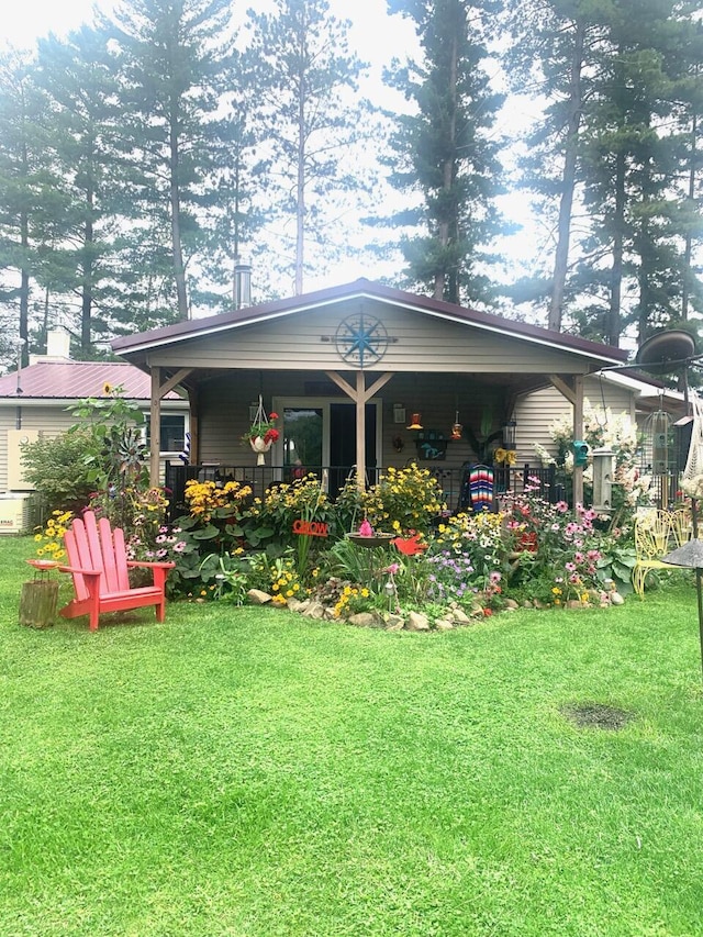 rear view of house featuring a yard