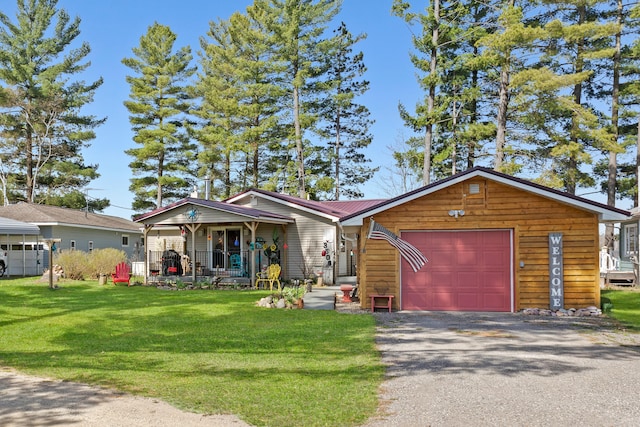 3509 N Shore Dr, Sears, MI 49679 - view of front of house featuring covered porch, metal roof, a front yard, a garage, and aphalt driveway