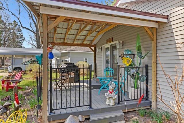 3509 N Shore Dr, Sears, MI 49679 - deck featuring a carport